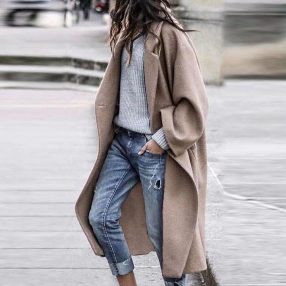 Khaki long coat with broad sleeves shown being worn.