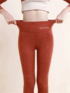 Maple red leggings with a wide waistband and small original white lettering.