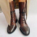 Brown lace-up boots with darker toe caps and low heels.