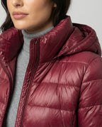 Close-up of the burgundy jacket’s hood, high neckline and front zip.
