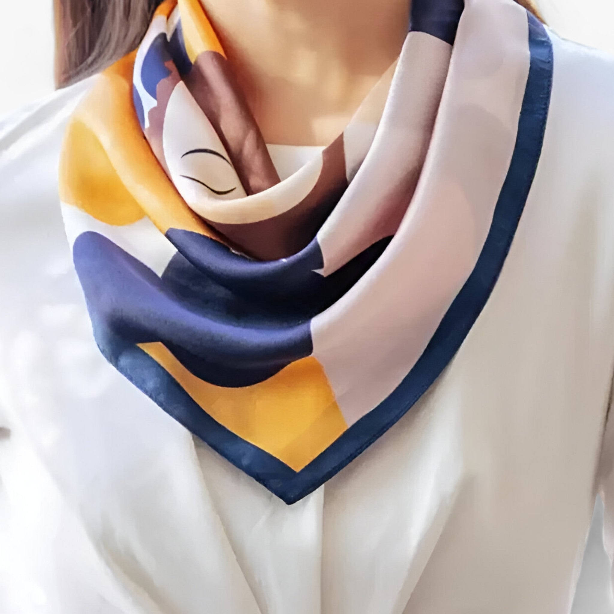 Colourful scarf with navy edging draped around the neck.