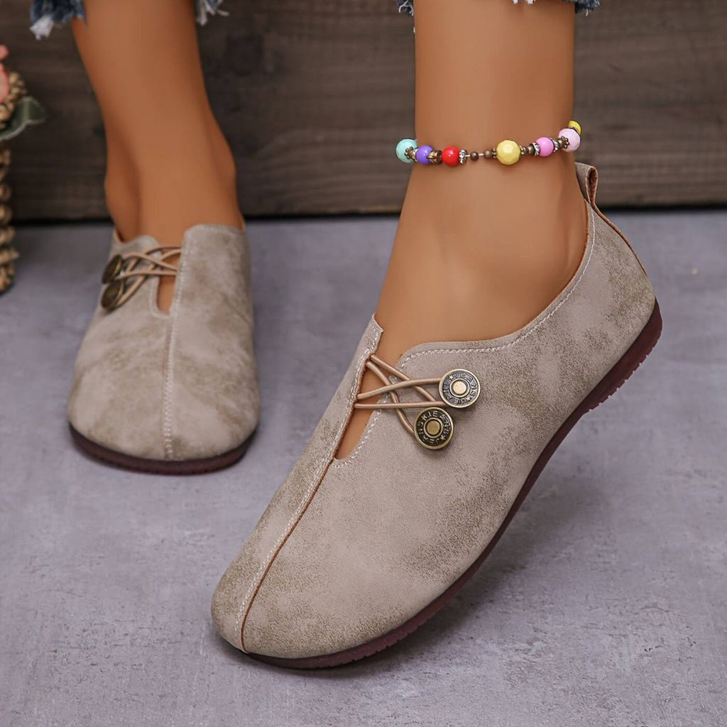 Light brown faux-leather shoes with round metal details.