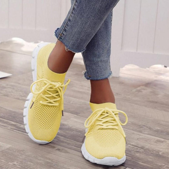Pale-yellow trainers with matching laces and white soles.