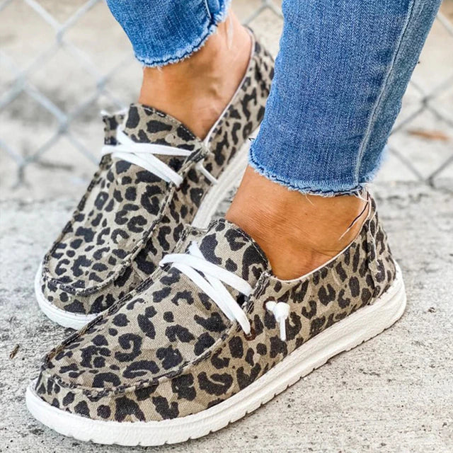 Leopard-print lace-up shoes with pale soles.