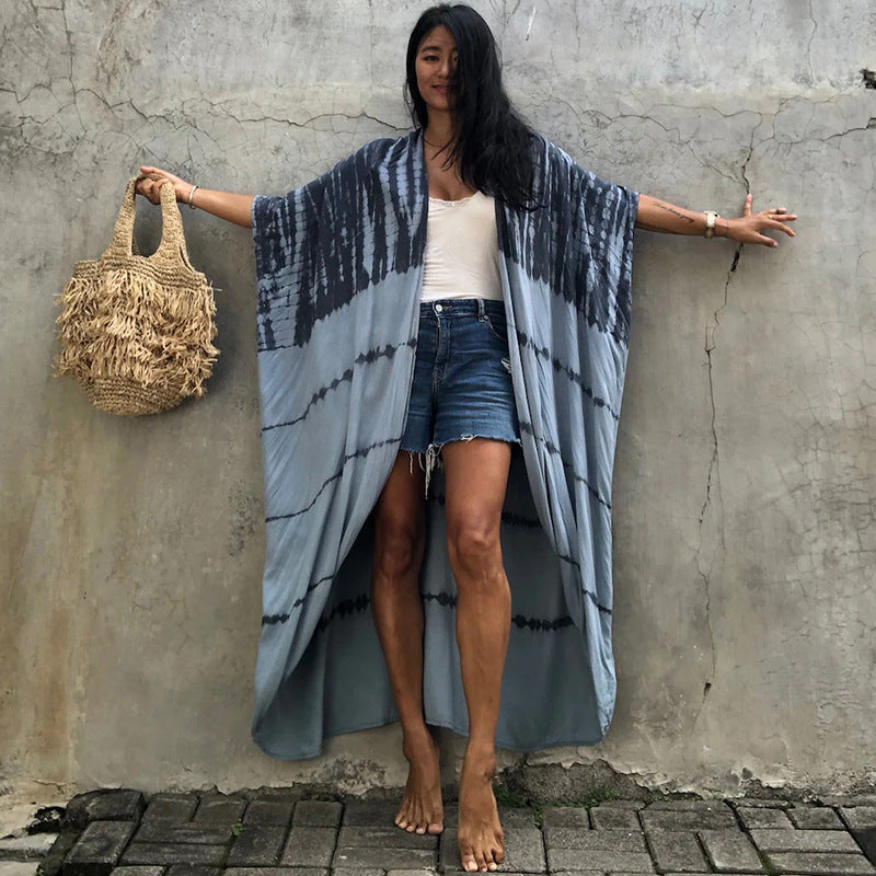 Grey and dark banded cover-up with sleeves held out.