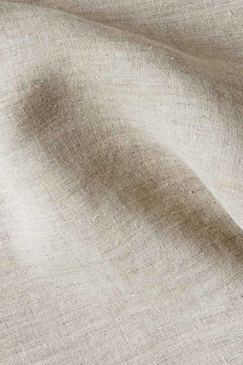 Close view of the woven texture of pale fabric.