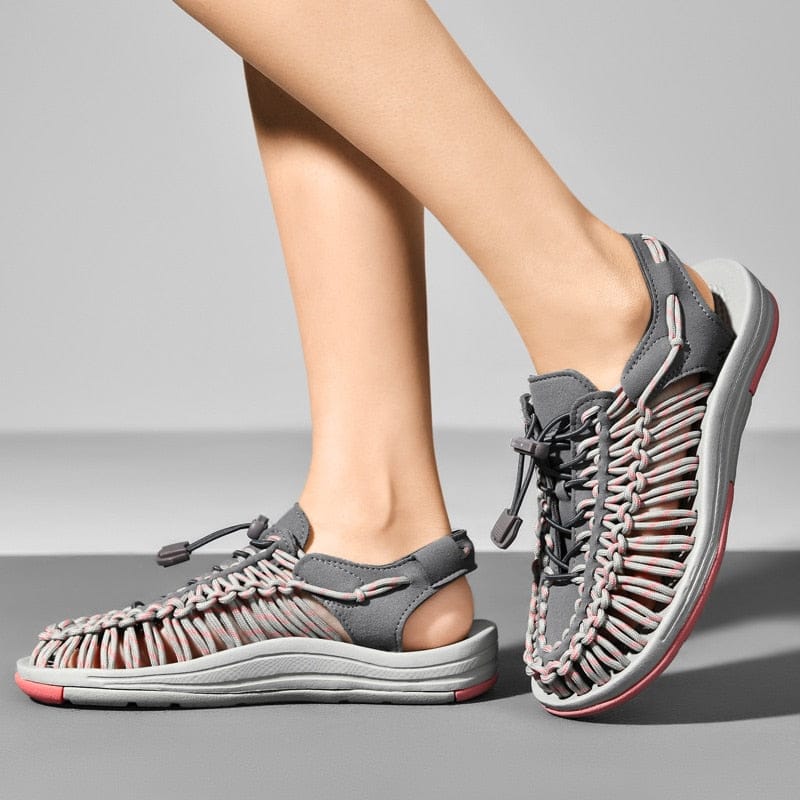 Grey and pink cord sandals worn in front and side views.