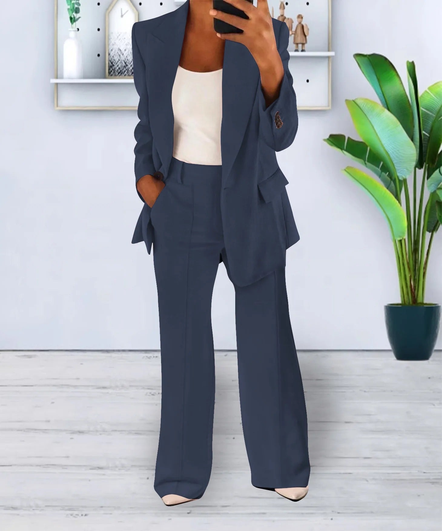Dark blue two-piece suit with a lapel jacket and full-length trousers.