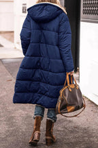 Rear view of the navy-blue quilted coat and hood.