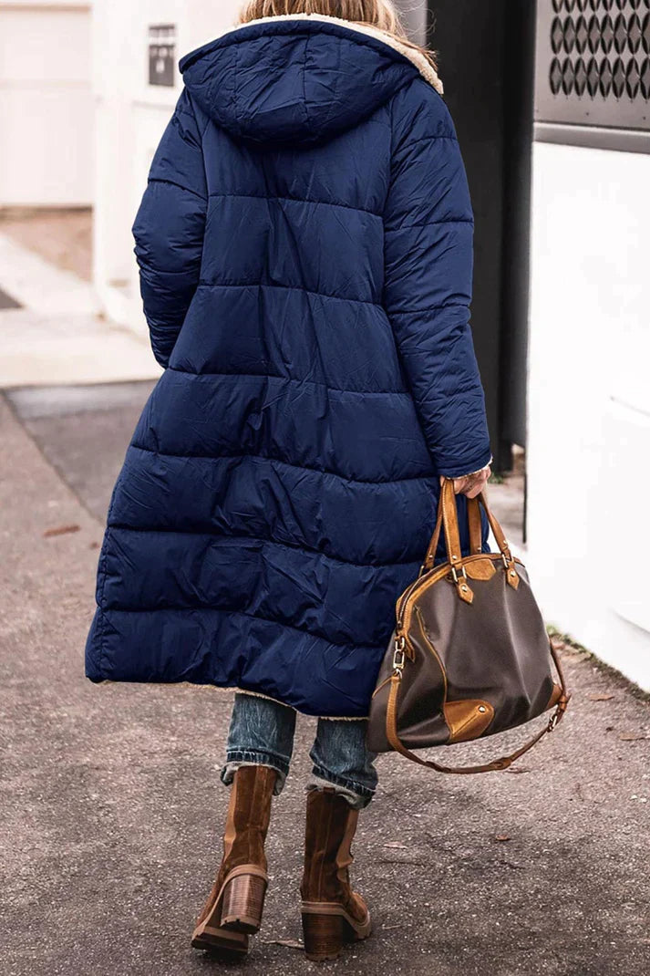 Rear view of the navy-blue quilted coat and hood.