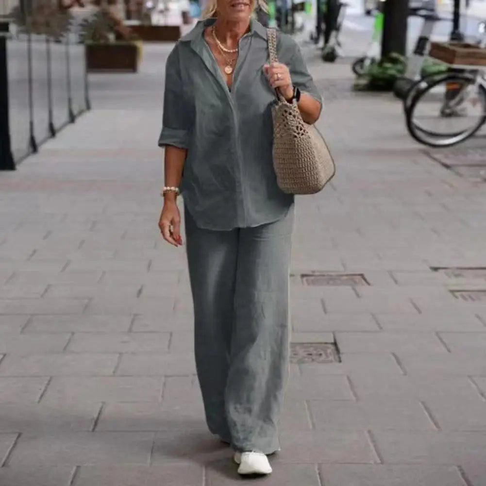Grey collared shirt and loose matching trousers worn outdoors.