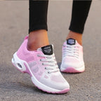 Grey and pink trainers with light-coloured laces.