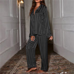 Black striped satin pyjama set with a button-front shirt.
