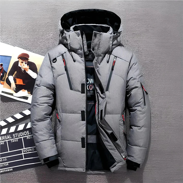 Grey hooded jacket with dark trim and multiple zipped pockets.