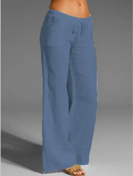 Blue loose-leg trousers shown against a grey background.