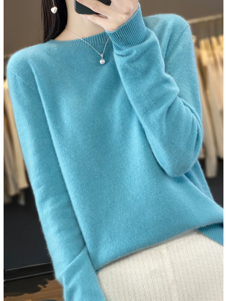 Turquoise jumper shown at an angle, with a ribbed hem.