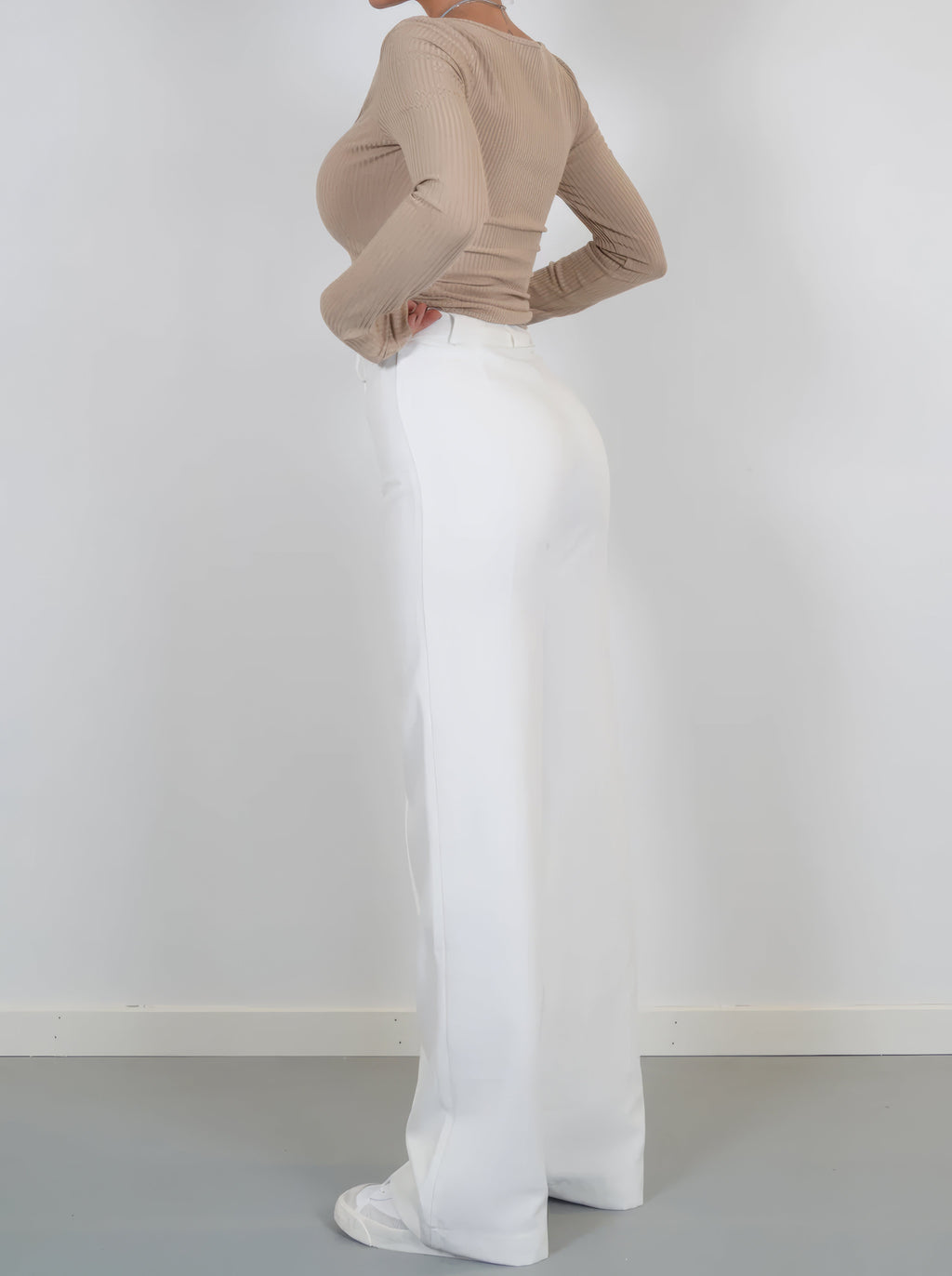 White wide-leg trousers viewed from the side.