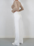White wide-leg trousers viewed from the side.