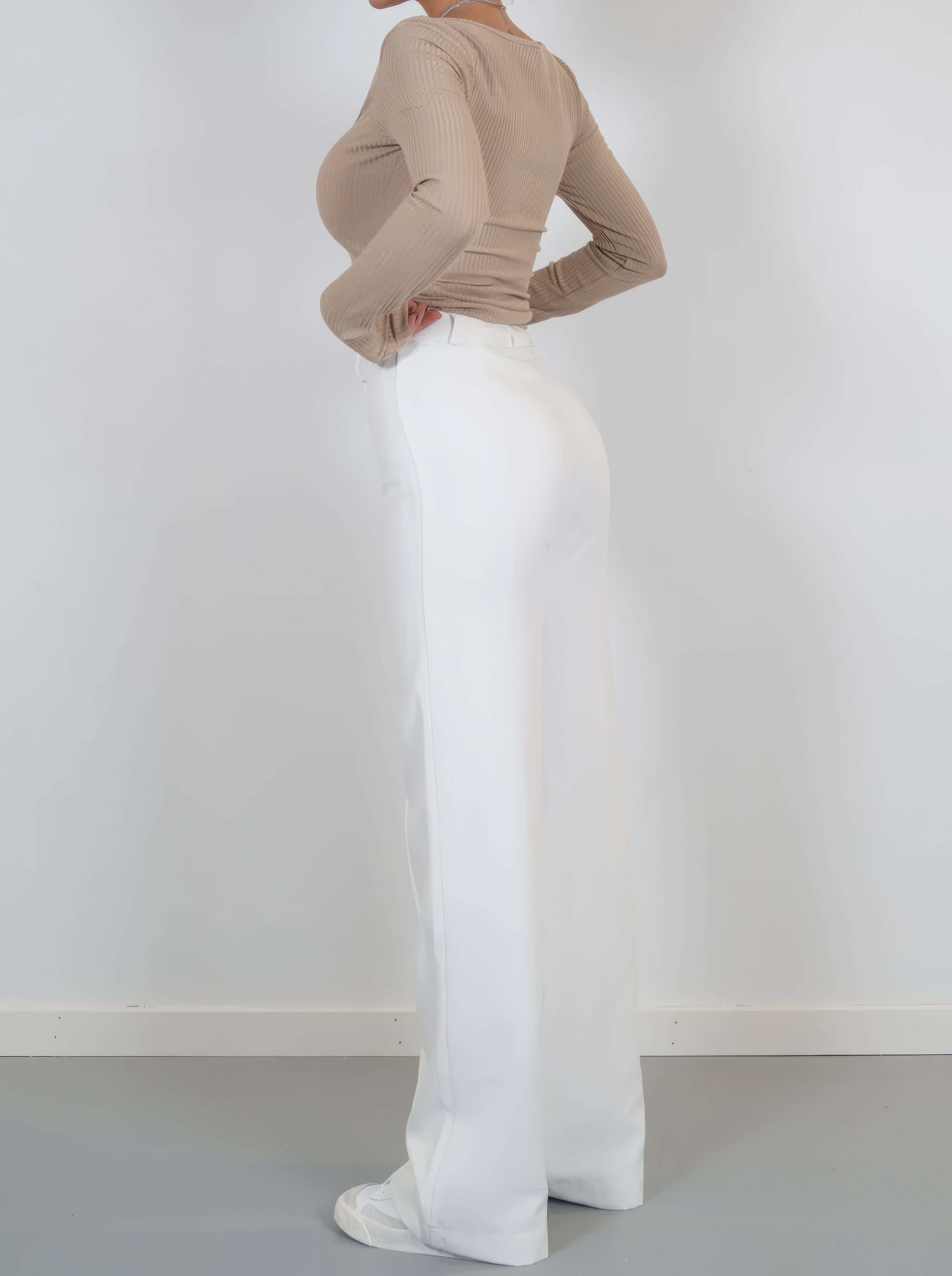 White wide-leg trousers viewed from the side.