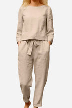 Front view of a beige top and tie-waist trousers.