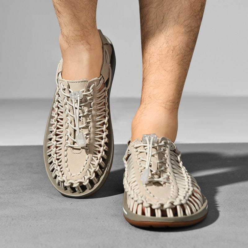 Beige cord sandals with toggle laces, shown on feet from above.