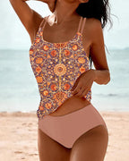 Pink Akira tankini set with a patterned top and plain bottoms.