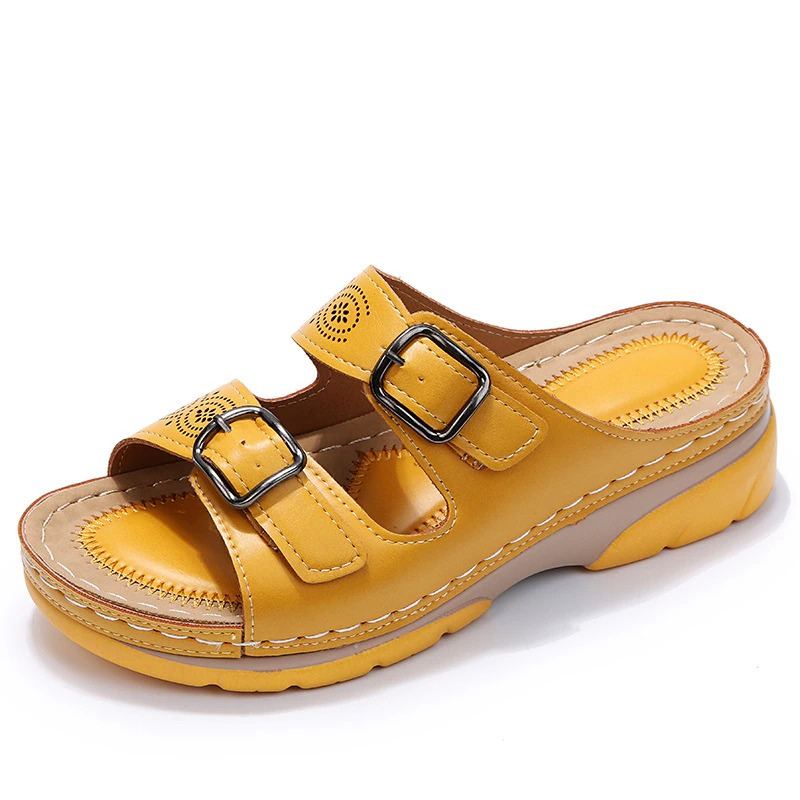 Yellow slide sandal with two buckle straps and a raised two-tone sole.