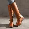Brown leather boots with ankle buckle straps and low block heels.