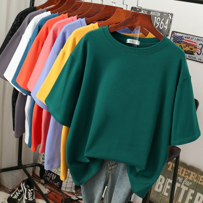 Dark green crew-neck T-shirt displayed with its lower edge loosely tucked.
