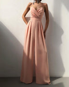 Pink wide-leg jumpsuit with a defined waistband.