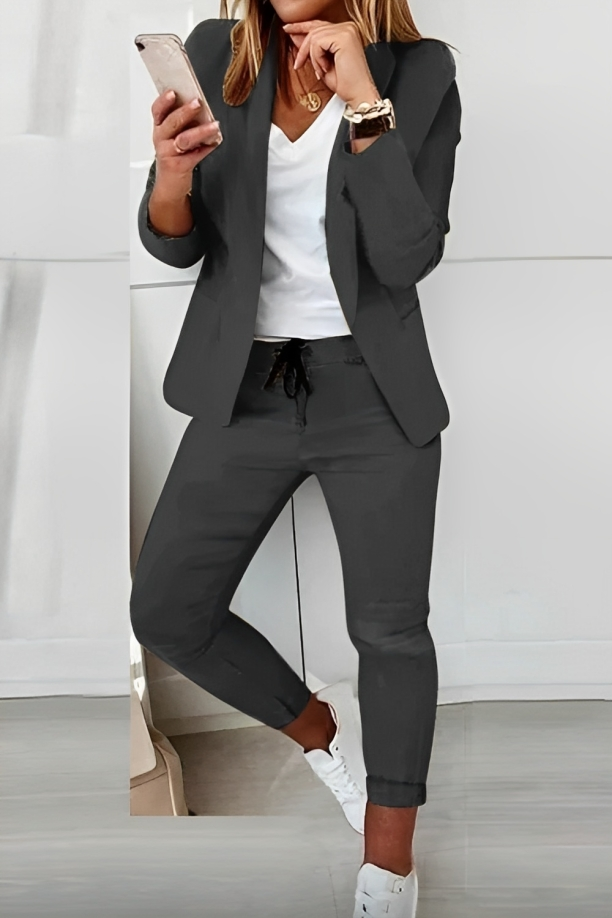 Dark Grey open-front blazer and drawstring trousers shown with a contrasting top and white trainers.