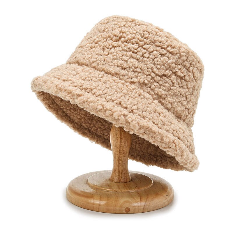 Beige bucket hat with a rounded crown and turned-down brim.