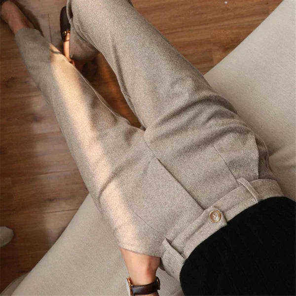 Light trousers with front pleats viewed from above.
