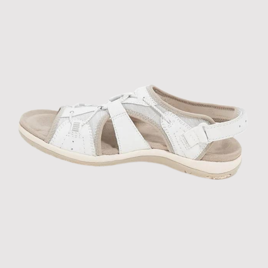 White sandal shown from the side with an adjustable heel strap.