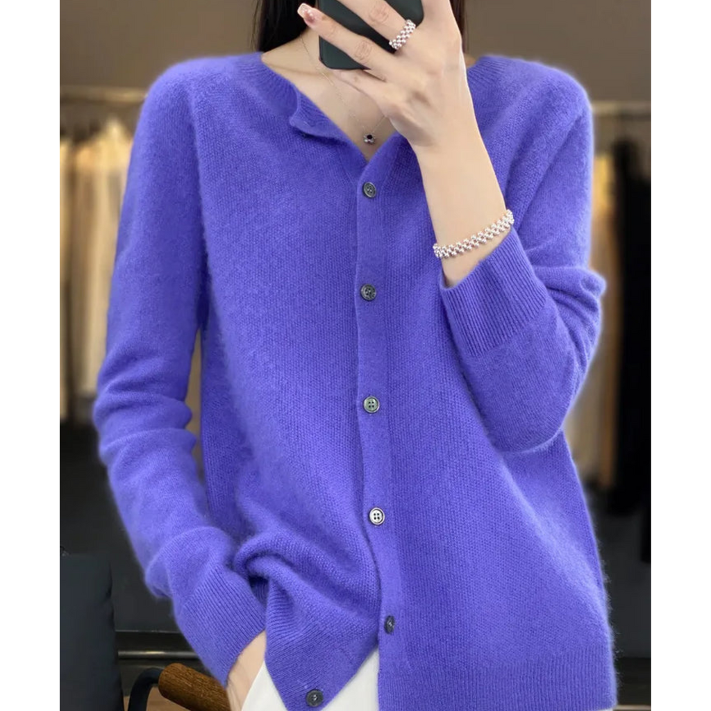 Blue-toned cardigan with a row of front buttons, shown on a model.
