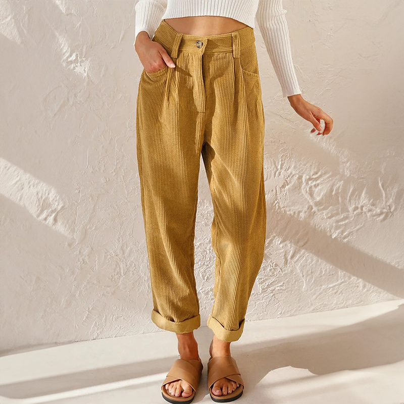 Mustard-yellow corduroy trousers with front pockets.