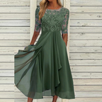 Green party dress with floral lace sleeves and a draped outer skirt.