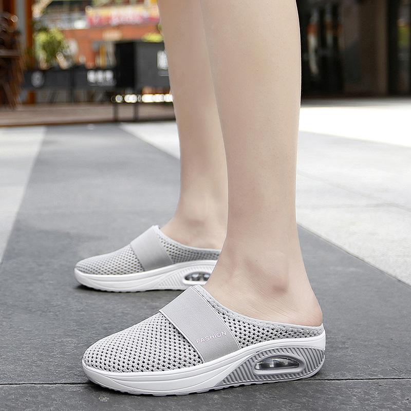 Pale grey mesh mules with contrasting white sole sections.