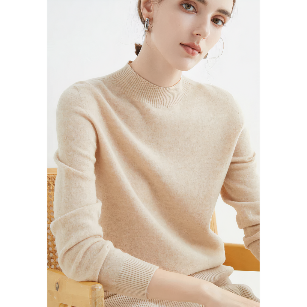Beige jumper viewed from an angle, with hands resting in front.