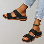 Black two-strap sandals with contrasting stitching around the sole.