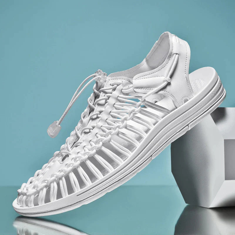 White cord sandal shown diagonally on a display block.