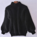 Black fuzzy jumper with full sleeves and a high ribbed neckline.