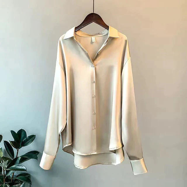 Champagne button-front shirt with a pointed collar and long cuffed sleeves on a hanger.