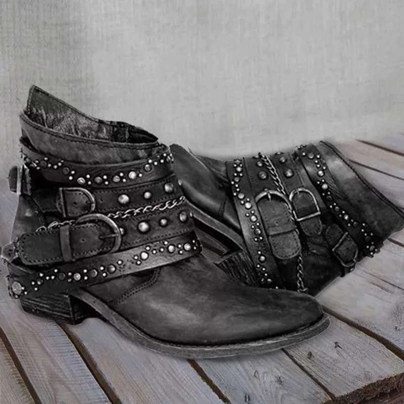 Black ankle boots with metallic studs and low heels.