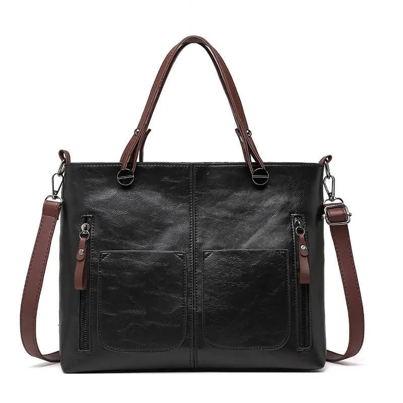Front view of the black handbag with twin handles.