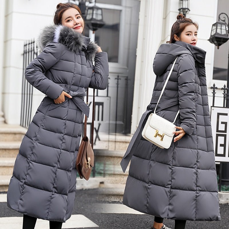 Grey long quilted coat with a hood and waist tie.