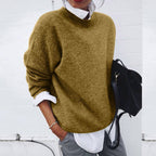 Ochre-coloured round-neck jumper layered over a white collared shirt.