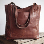 Coffee brown tote bag standing upright with visible edge stitching.