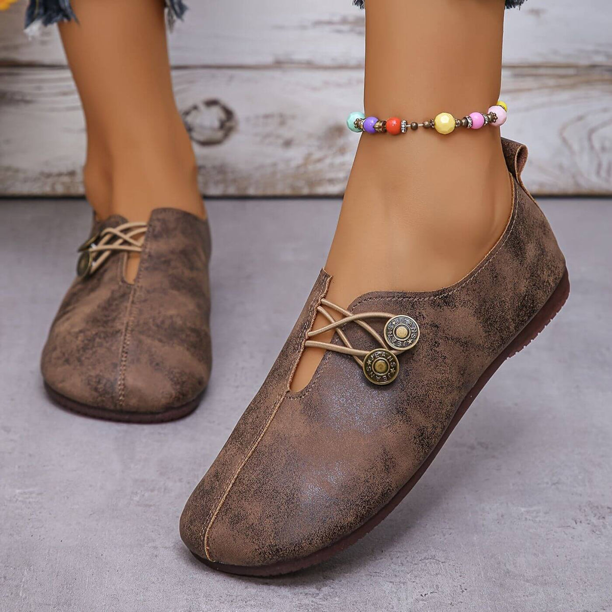 Dark brown shoes with centre seams and rounded toes.