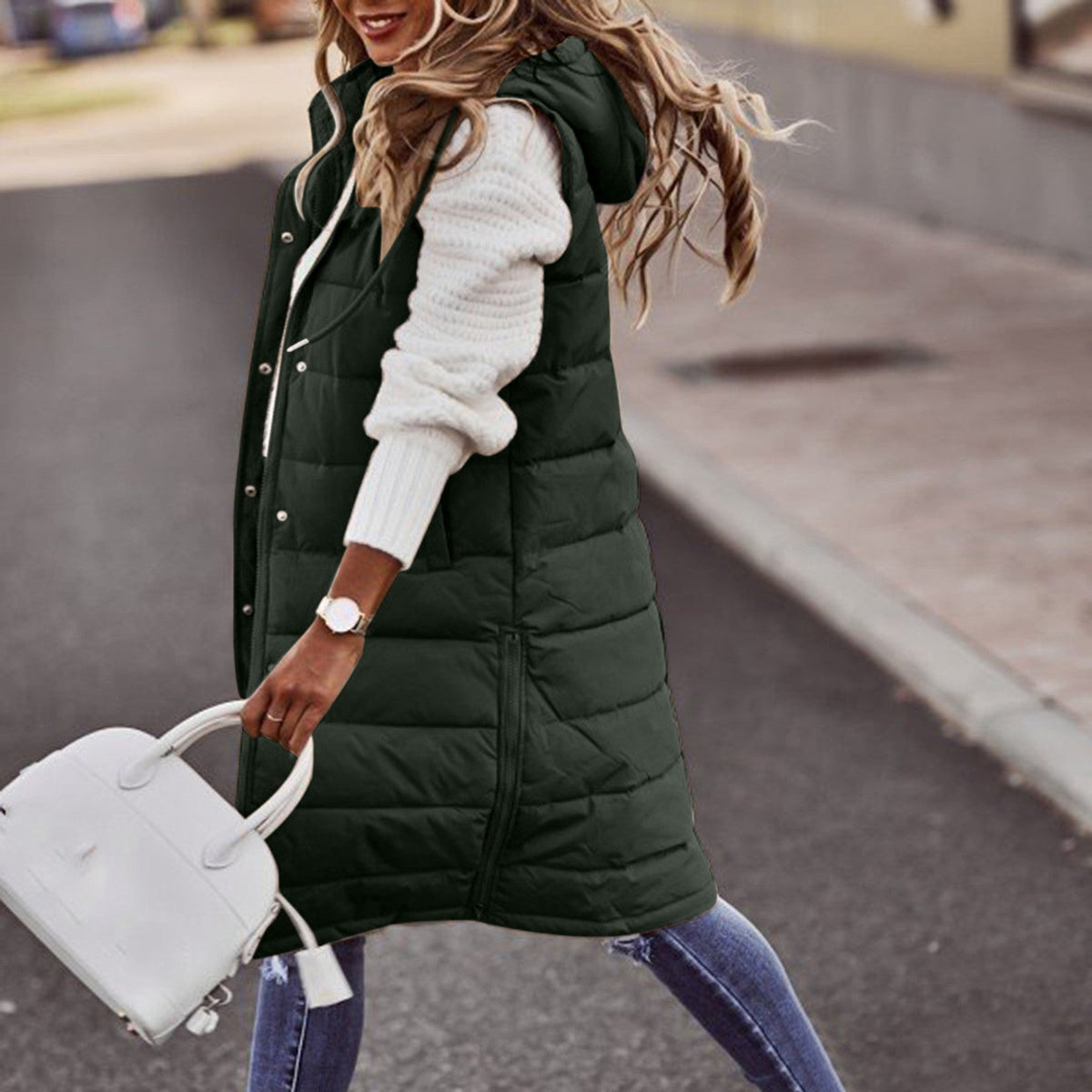 Army green long quilted gilet with a hood and side pockets.